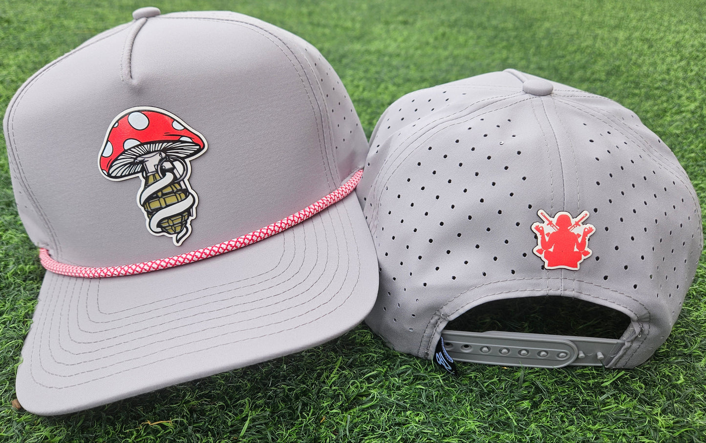 Two gray caps with unique designs on a grass background