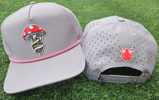 Two gray caps with unique designs on a grass background